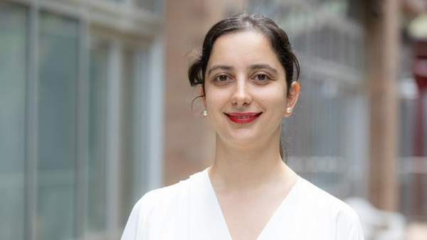 Phd student Fatma Kara smiling and wearing white
