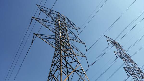 Electrical power lines, blue sky in background