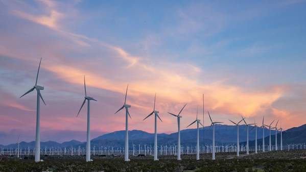 Wind turbines, sunset in background