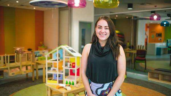 Kayla standing in early learning room