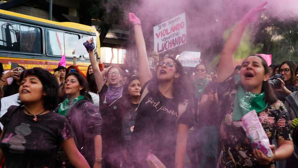 Women toss pink glitter during a protest march demanding justice and for their safety, sparked by two recent alleged rapes by police, in Mexico City, Friday, Aug. 16, 2019. (AP Photo/Marco Ugarte)