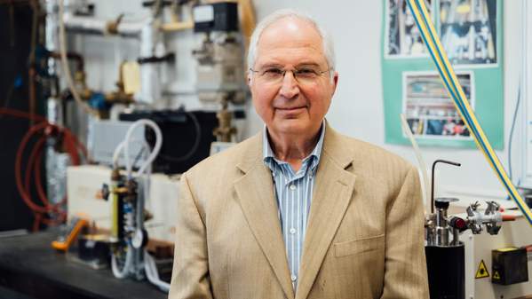 Distinguished Professor Anatoly Rozenfeld smiles as he stands in a laboratory. Photo: Paul Jones