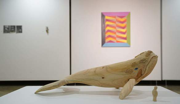 A wood carved whale on display at the UOW Art Gallery Auction 2022