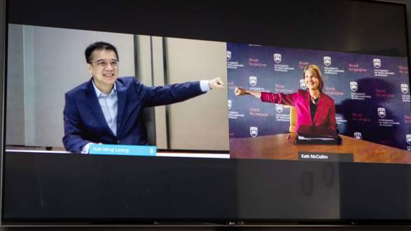 Two CEO signatories doing COVID-safe handshake over video conference