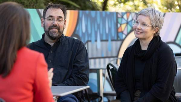 Researchers interviewing essential worker