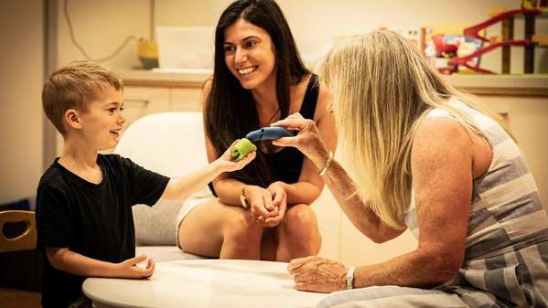 Ashleigh and her son engage in some playtime with an Early Start Denver Model therapist ESDM therapist Netti Heslewood.