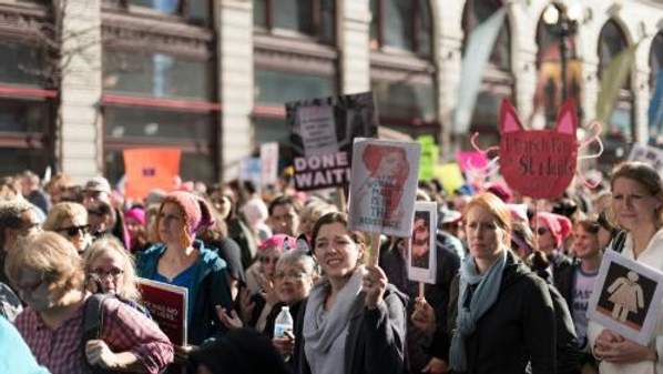 People holding signs up at a protest