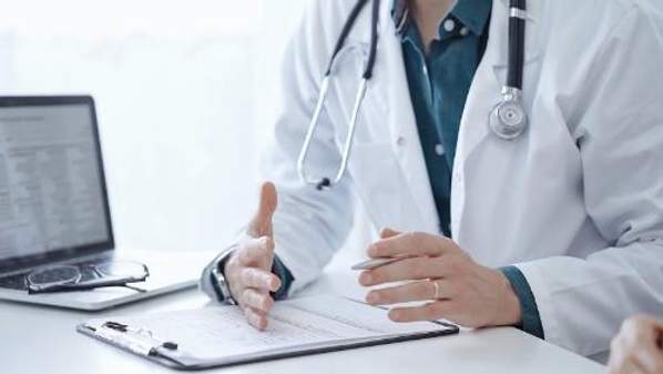 Generic image of a doctor sitting at a desk