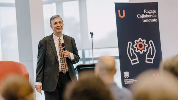 George Tomka, Senior Manager Business Development, presents at the Innovation Showcase, with lectern and banner in the background. Photo: Michael Gray