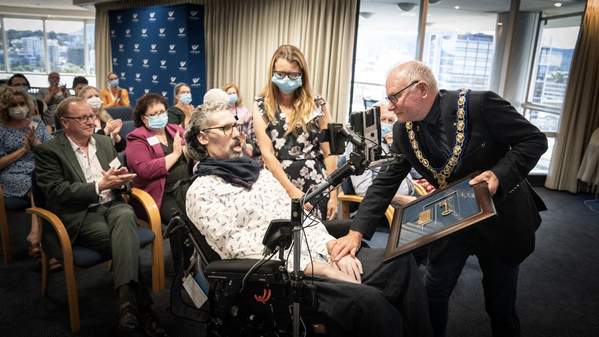 Professor Justin Yerbury is given the a plaque with a Key to the City of Wollongong by Wollongong Lord Mayor Gordon Bradbery during a ceremony at council. Photo: Paul Jones