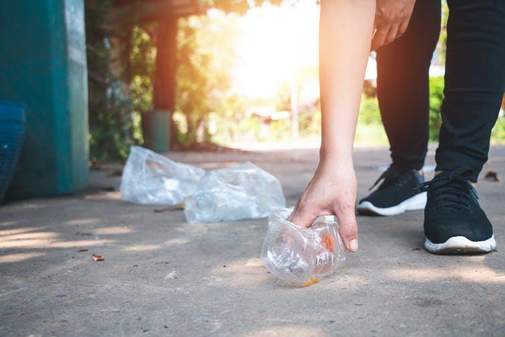 A student picking up litter