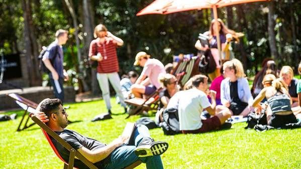 Students on the duck pond lawn on a sunny day