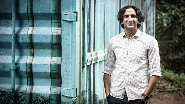Narayan Khanal stands next to a shipping container. Photo: Paul Jones