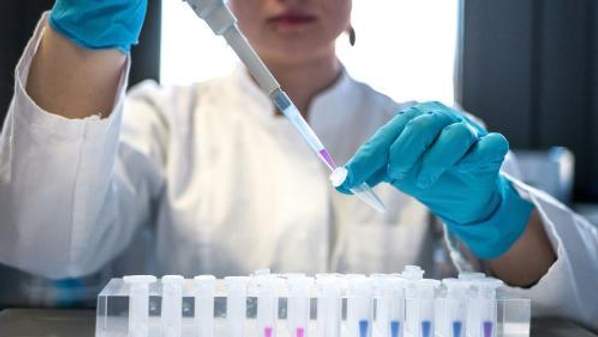 Person holding test tubes