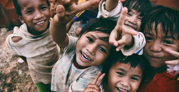 A group of children smile for the camera in Vietnam. Photo: Larm Rmah/Unsplash