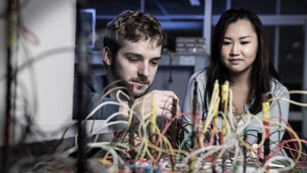 Two UOW physics students engaged in hands on learning in the lab.