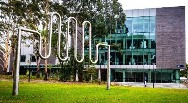 An image of a sculpture in the foreground, with the Jillian Broadbent Building in the background, on UOW's 51 campus. Photo: Paul Jones