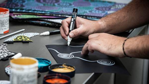 Artist Zac Bennett Brooks creating an artwork with pen on paper