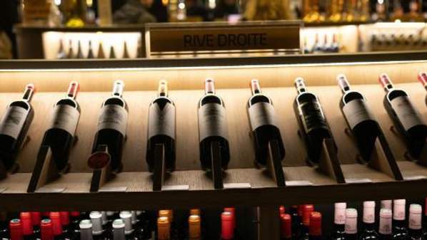 Red wine bottles on a shelf