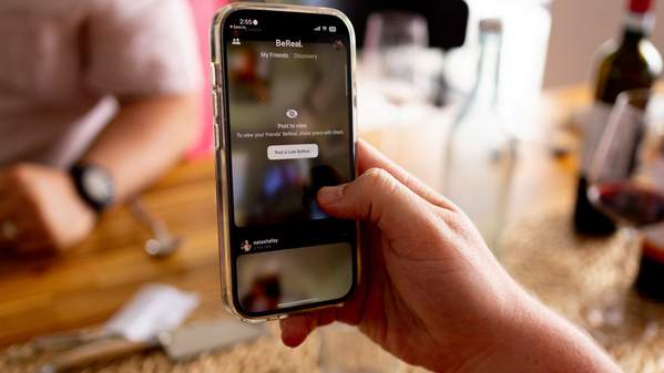 An up-close image of a phone showing a social media platform. Photo: Unsplash