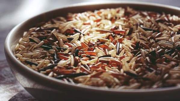 Red, black and white grains of rice in a bowl.