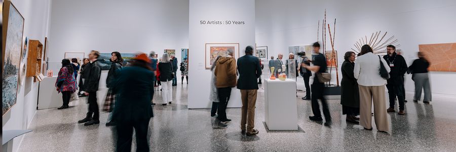 The gallery is bustling with supporters of the 50 artists 50 years exhibition