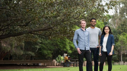 Group of international students standing on the duckpond lawn