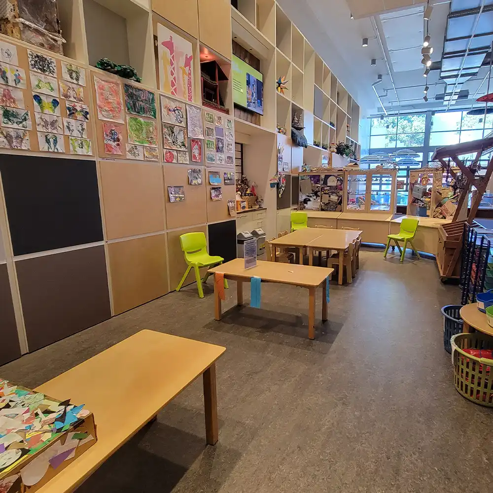 There are tables and buckets with all kinds of arts and crafts