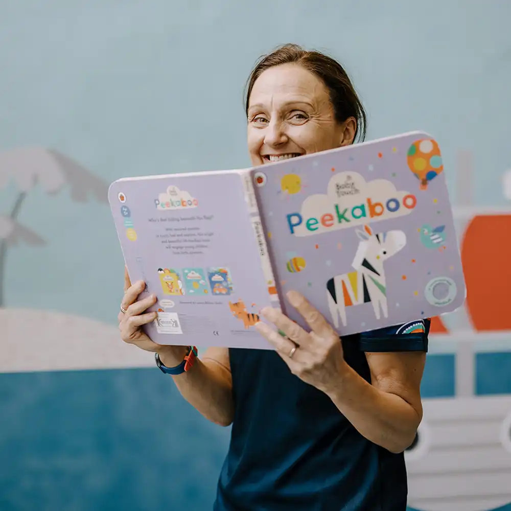 Jess Mantei peeks over a book titled 'Peekaboo'