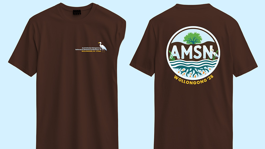 Front and back views of a chestnut-brown conference T-shirt designed for the Australasian Mangrove and Saltmarsh Network (AMSN) Conference 2026. The front features a small conference logo on the left chest with event text including “Wollongong, 24-27 Nov”. The back displays a large circular AMSN logo incorporating a mangrove tree, waterways, saltmarsh vegetation and root system imagery, with the t