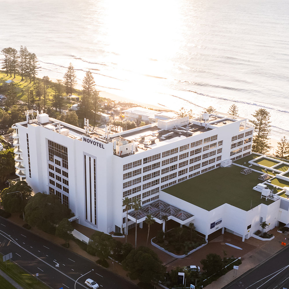 A modern white hotel labeled 