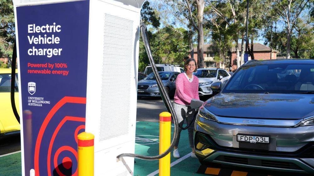 A woman charging her electric vehicle