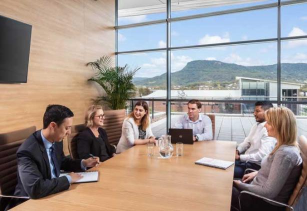 people sitting around a board room table at ICR