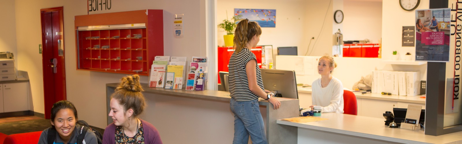 Student talking to staff at a desk