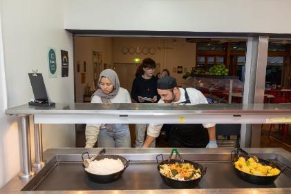 Students serving themselves food from a buffet