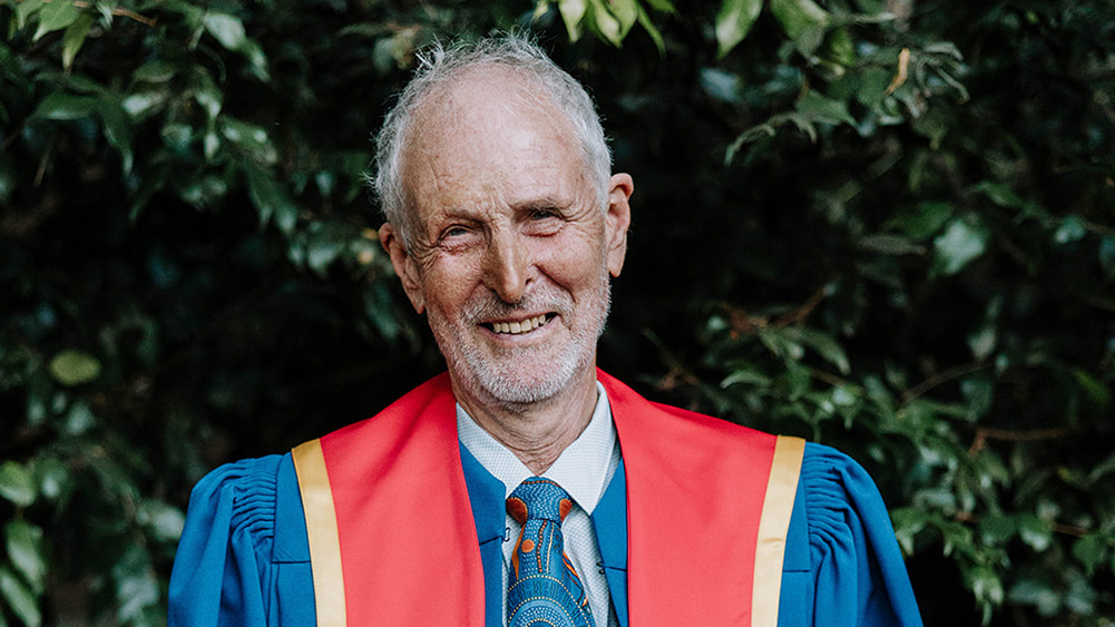 Andrew FitzSimons wears a red honorary gown.