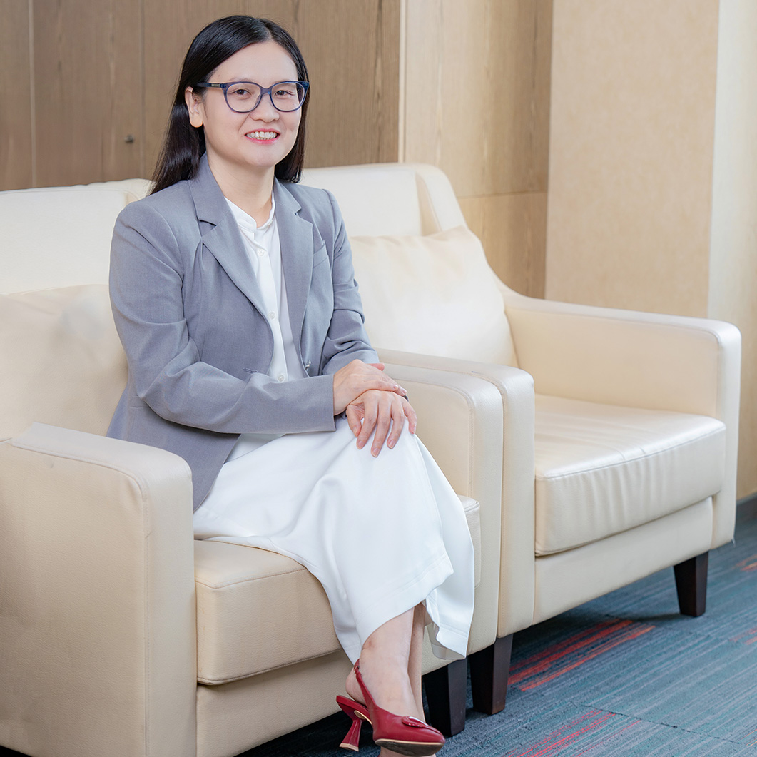 Portrait of Ngoc Anh Nguyen seated in an office setting.