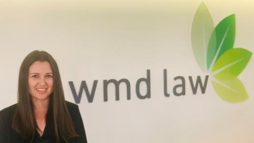 Anika next to WMD Lawyers sign