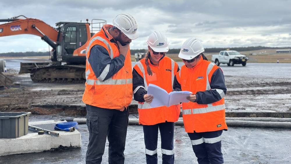 Group of engineers looking a site plan