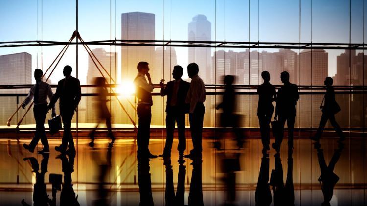 Silhouettes of employees in a large office building