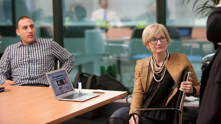 Female executive sits in the Sydney Business School boardroom