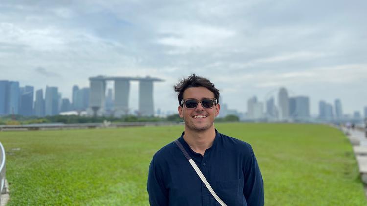 Carlo Teodorowych, a final-year UOW Bachelor of Laws student in Singapore. City landscape in background.