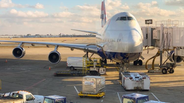 Landed plane with cargo containers on runway