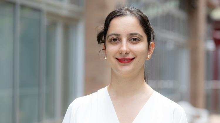Phd student Fatma Kara smiling and wearing white