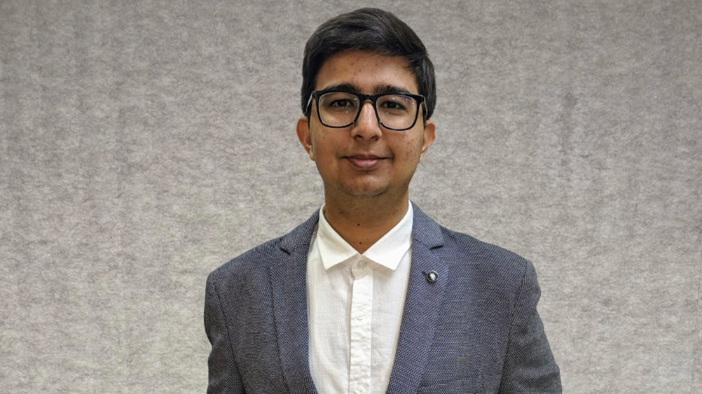 Sydney Business School, UOW student, Karan Roshanlal Golani wears a shirt and business jacket.