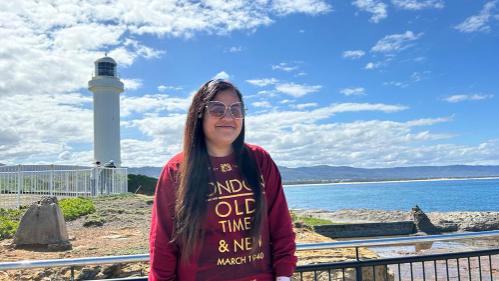 Sydney Business School, ������ýapp Student, Shruti Juneja stands near ������ýapp Lighthouse.