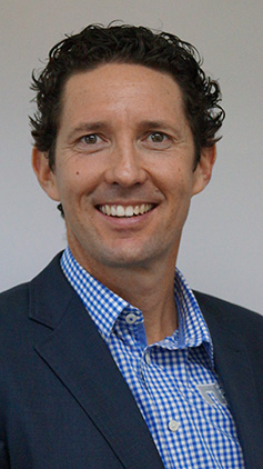 Peter Buckley wears a shirt and a jacket.