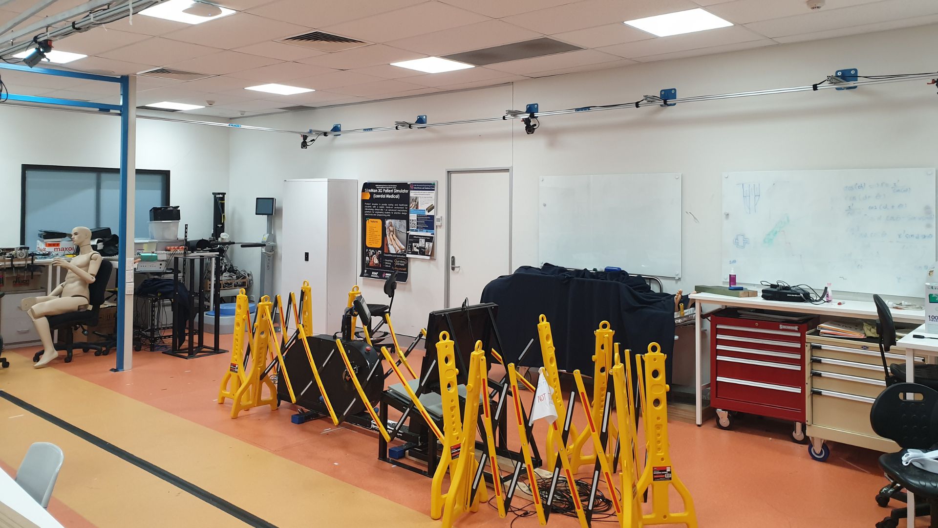 A biomedical engineering laboratory featuring motion capture equipment, simulation tools, and research workstations