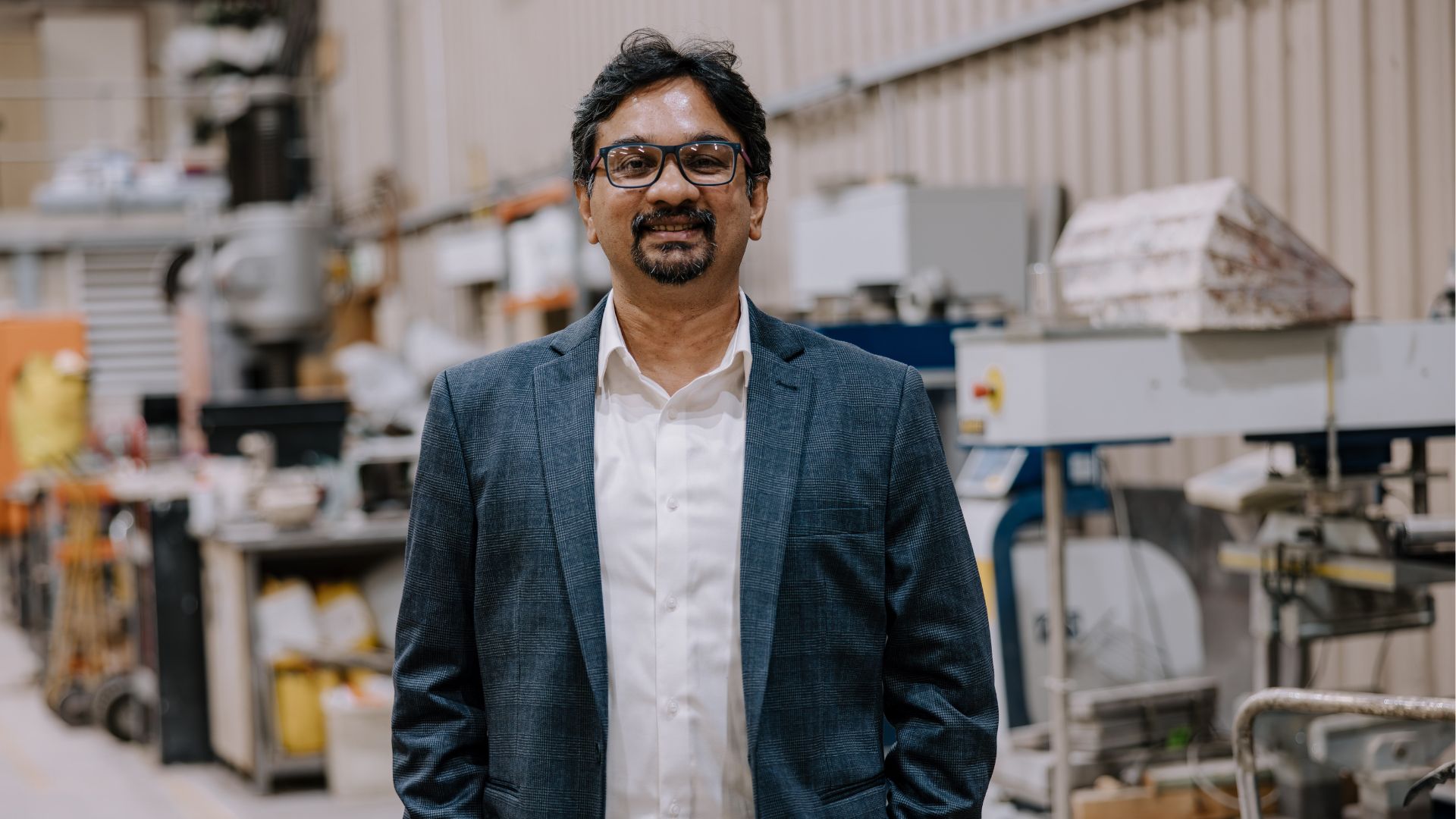 Portrait of a man standing in an engineering workshop