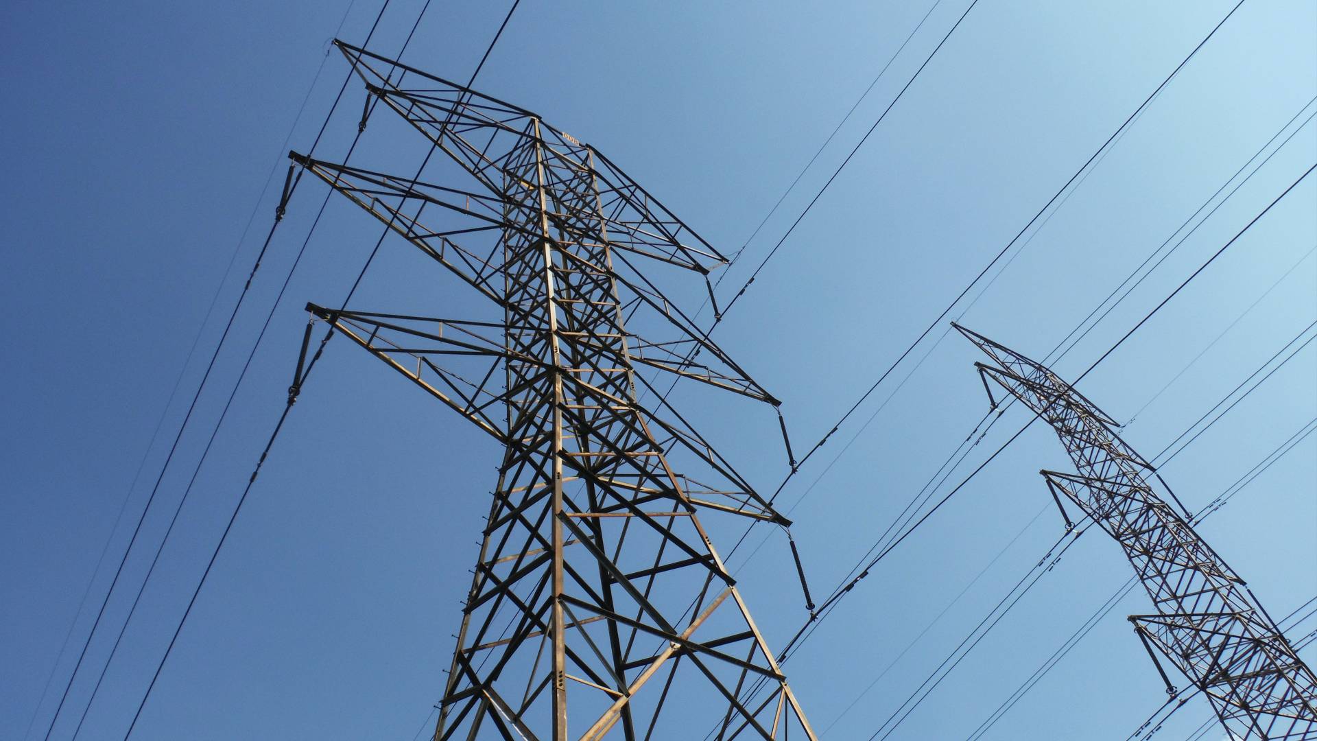 Electrical power lines, blue sky in background